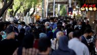 FILE PHOTO: Iranians wearing protective face masks against the coronavirus walk in a crowded area of the capital Tehran, Iran, March 30, 2021. Majid Asgaripour/WANA (West Asia News Agency) via REUTERS/