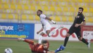Jonathan Kodjia (centre) scores Al Gharafa's fourth goal against Umm Salal at Qatar SC Stadium yesterday. 