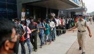 A police officer points at people in line at a railway station amidst the spread of the coronavirus disease (COVID-19) in Mumbai, India, April 11, 2021. REUTERS/Francis Mascarenhas TPX IMAGES OF THE DAY

