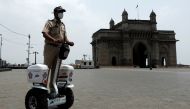 A police officer patrols on a Segway along the promenade outside the Gateway of India during a curfew to limit the spread of the coronavirus disease (COVID-19) in Mumbai, India, April 10, 2021. REUTERS/Francis Mascarenhas
