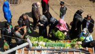 People shop for vegetables at a souk in Beirut, Lebanon April 12, 2021. Picture taken April 12, 2021. REUTERS/Issam Abdallah