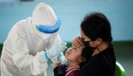 A healthcare worker takes a nasal swab sample from a child for a coronavirus disease (COVID-19) test, as the country deals with a fresh wave of infections after tackling earlier outbreaks, in Bangkok, Thailand April 16, 2021. REUTERS/Athit Perawongmetha/F