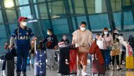 Visitors walk after they arrived at the Soekarno-Hatta Airport following Indonesia's government decision to ban foreign tourists from entry to prevent the spread of coronavirus disease (COVID-19), in Tangerang, on the outskirts of Jakarta, Indonesia, Janu