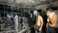 People look on at Ibn Khatib hospital after a fire caused by an oxygen tank explosion in Baghdad, Iraq, April 25, 2021. Reuters/Thaier Al-Sudani
