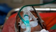 A patient wearing an oxygen mask is seen inside an ambulance waiting to enter a COVID-19 hospital for treatment, amidst the spread of the coronavirus disease (COVID-19) in Ahmedabad, India, April 25, 2021. Reuters/Amit Dave