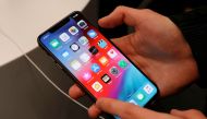 A customer tests a smartphone during the launch of the new iPhone XS and XS Max sales at 