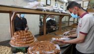 A worker sells sweets to customers during the holy fasting month of Ramadan in Beirut, Lebanon April 22, 2021. Picture taken April 22, 2021. REUTERS/Mohamed Azakir