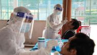 Medical workers collect swab samples from people at a coronavirus disease (COVID-19) testing centre in Petaling Jaya, Malaysia January 25, 2021. REUTERS/Lim Huey Teng

