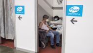 FILE PHOTO: A man receives a second dose of the Pfizer-BioNTech vaccine against the coronavirus disease (COVID-19) at the hall three of the Belgrade Fair, in Belgrade, Serbia, April 13, 2021. REUTERS/Marko Djurica/File Photo
