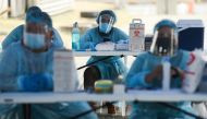Health workers wait for the arrival of residents to be vaccinated against the coronavirus disease (COVID-19) at a drive-thru vaccination site for bedridden and persons with disabilities, in Makati city, Metro Manila, Philippines, May 7, 2021. REUTERS/Lisa