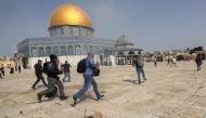 A member of Israeli police runs after a cameraman during clashes with Palestinians at the compound that houses Al-Aqsa Mosque, known to Muslims as Noble Sanctuary and to Jews as Temple Mount, in Jerusalem's Old City, May 10, 2021. REUTERS/Ammar Awad