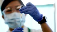 FILE PHOTO: A medical worker fills a syringe with a dose of the Pfizer-BioNTech coronavirus disease (COVID-19) vaccine, at Tokyo Medical Center in Tokyo, Japan February 17, 2021. Behrouz Mehri/Pool via REUTERS