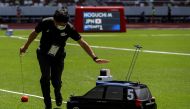 Olympics - Tokyo 2020 Olympic Games Test Event - Athletics - Olympic Stadium, Tokyo, Japan - May 9, 2021. A remote controlled miniature car, developed by Toyota Motor for use in track and field throwing events, is seen during the men's hammer throw event 