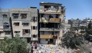 Palestinians gather around a house after it was hit by an Israeli air strike, amid a flare-up of Israeli-Palestinian violence, in the southern Gaza Strip May 12, 2021. REUTERS/Ibraheem Abu Mustafa