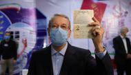 Ali Larijani, former chairman of the parliament of Iran, shows his identification document as he registers as a candidate for the presidential election at the Interior Ministry, in Tehran, Iran May 15, 2021. Majid Asgaripour/ WANA (West Asia News Agency) 