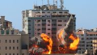 The al-Jalaa building housing Associated Press (AP) and Al Jazeera media offices is hit by an Israeli air strike in Gaza City, May 15, 2021. REUTERS/Ashraf Abu Amrah