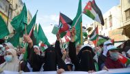 Demonstrators hold flags during a protest to express solidarity with the Palestinian people, in downtown Amman, Jordan May 16, 2021. REUTERS/Muath Freij
