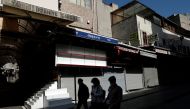 FILE PHOTO: People walk past by closed shops at deserted Mahmutpasa street, a popular middle-class shopping district, during a nationwide 