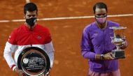 Spain's Rafael Nadal with the trophy after winning his final match against Serbia's Novak Djokovic who poses with the runners up trophy REUTERS/Guglielmo Mangiapane