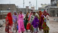 Women with their children leave their houses and evacuate to a safer place ahead of Cyclone Tauktae in Veraval in the western state of Gujarat, India, May 17, 2021. Reuters/Amit Dave