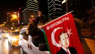 A pro-Palestinian demonstrator holds a flag with an image of Turkish President Tayyip Erdogan as they drive past by the Israeli Consulate in Istanbul, Turkey May 12, 2021. REUTERS/Dilara Senkaya