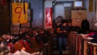 A woman uses her phone while experiencing a blackout due to an outage at a power plant, in Taipei, Taiwan, May 13, 2021. REUTER/Ann Wang/File Photo