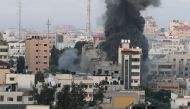 Smoke rises following an Israeli airstrike on a building in Gaza City May 18, 2021. REUTERS/Mohammed Salem