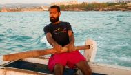 Ali Sleem, sits on a fishing boat in Sarafand, Lebanon May 10, 2021. Picture taken May 10, 2021. Reuters/Issam Abdallah