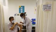 A nurse administers a dose of the AstraZeneca vaccine against the coronavirus disease (COVID-19) during a vaccination session for healthcare workers following the recent rise in COVID-19 infections, at Far Eastern Memorial Hospital in New Taipei City, Tai