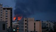 Smoke and flames are seen above buildings, amid a flare-up of Israeli-Palestinian fighting, in Gaza, May 20, 2021. REUTERS/Mohammed Salem
