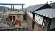 Rescue workers help transfer belongings from a damaged house following an earthquake in Yangbi county, Dali prefecture, Yunnan province, China May 22, 2021.