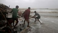 Men remove bamboo rooftop of a stall damaged by heavy winds at a shore ahead of Cyclone Yaas in Bichitrapur in Balasore district in the eastern state of Odisha India, May 26, 2021. REUTERS/Rupak De Chowdhuri