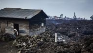 A woman prepares to evacuate from recurrent earth tremors as aftershocks after homes were covered with lava deposited by the eruption of Mount Nyiragongo near Goma, in the Democratic Republic of Congo May 25, 2021. Hugh Kinsella Cunningham/Save the Childr