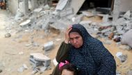 A Palestinian woman puts her hand on her head after returning to her destroyed house following Israel- Hamas truce, in Beit Hanoun in the northern Gaza Strip on May 21, 2021. (REUTERS/Mohammed Salem/File Photo)
