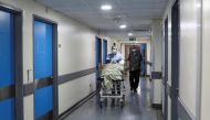 A healthcare worker wheels a patient inside a hospital in Beirut, Lebanon May 31, 2021. Reuters/Mohamed Azakir