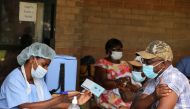 A man receives a certificate after being vaccinated against the coronavirus disease (COVID-19) at Wilkins Hospital in Harare, Zimbabwe, March 24, 2021. REUTERS/Philimon Bulawayo/File Photo