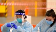 Health workers are seen at work at a drive-through coronavirus disease (COVID-19) testing facility in Melbourne, Australia, June 7, 2021. AAP Image/Luis Ascui via REUTERS