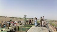 Paramilitary soldiers and rescue workers gather at the site following a collision between two trains in Ghotki, Pakistan June 7, 2021. Inter-Services Public Relations (ISPR)/ Handout via REUTERS