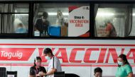 Health workers encode information and prepare vaccines against the coronavirus disease (COVID-19) at a mobile vaccination site in Taguig, Metro Manila, Philippines, May 21, 2021. REUTERS/Lisa Marie David/File Photo