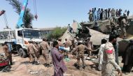 Paramilitary soldiers and rescue workers gather at the site following a collision between two trains in Ghotki, Pakistan June 7, 2021. Inter-Services Public Relations (ISPR)/ Handout via REUTERS