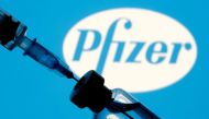 FILE PHOTO: A vial and syringe are seen in front of a displayed Pfizer logo in this illustration taken January 11, 2021. REUTERS/Dado Ruvic/Illustration