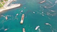 Aerial view of cleaning vessels and boats sailing through the sea covered with a plague of sea snot, a thick slimy layer of the organic matter also known as marine mucilage, spreading through the Sea of Marmara and posing a threat to marine life and the f