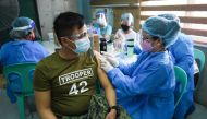 A police officer receives his first dose of Sinovac Biotech’s CoronaVac vaccine for the coronavirus disease (COVID-19) during the vaccination of essential workers, at the Navotas Fish Port, in Navotas City, Metro Manila, Philippines, June 10, 2021. REUTER