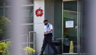 A police officer walks outside the headquarters of Apple Daily and Next Media after police arrested five Apple Daily executives who were suspected to have breached the new national security law, in Hong Kong, China June 17, 2021. Reuters/Lam Yik