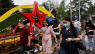 People walk past an installation marking the upcoming 100th founding anniversary of the Communist Party of China, in Beijing, China, June 16, 2021. (Reuters/Thomas Peter)