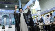 Presidential candidate Ebrahim Raisi gestures after he votes during presidential elections at a polling station in Tehran, Iran June 18, 2021. 
