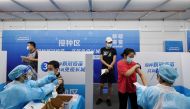 Residents receive vaccines against the coronavirus disease (COVID-19) at a makeshift vaccination site in Guangzhou, Guangdong province, China June 21, 2021. cnsphoto via REUTERS

