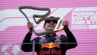 Red Bull's Max Verstappen celebrates with the trophy after winning the race Pool via REUTERS/Darko Vojinovic