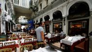 FILE PHOTO: A staff member stands next to empty tables as cafes and restaurants reopen after closing down for months amid the coronavirus disease (COVID-19) outbreak, in Istanbul, Turkey June 1, 2021. REUTERS/Dilara Senkaya