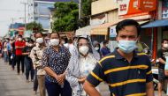 People wait in line before being vaccinated against coronavirus disease (COVID-19) in Phnom Penh, Cambodia, April 22, 2021. REUTERS/Cindy Liu/File Photo